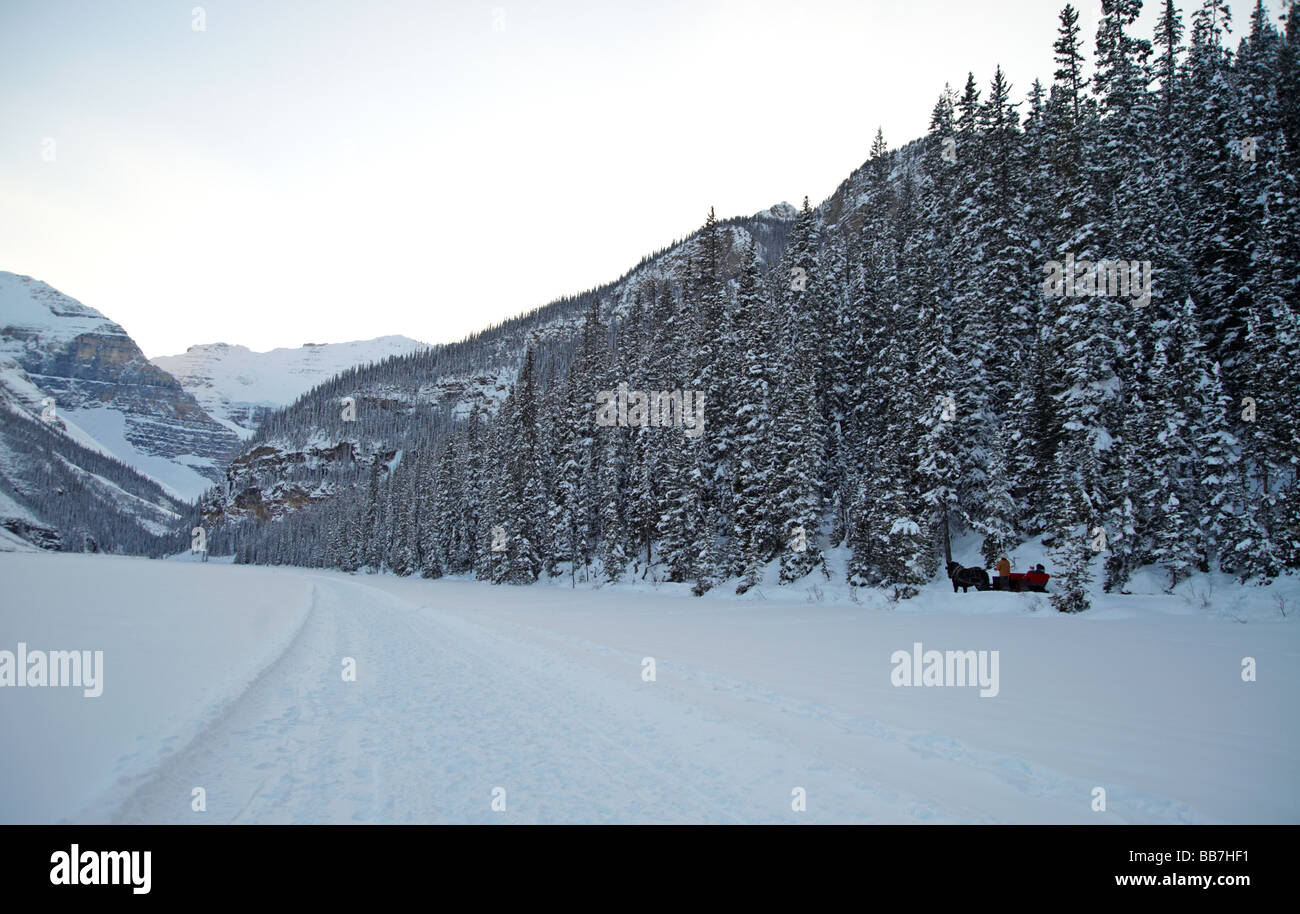 Sleigh ride along frozen lake shore, Lake Louise, Banff National Park