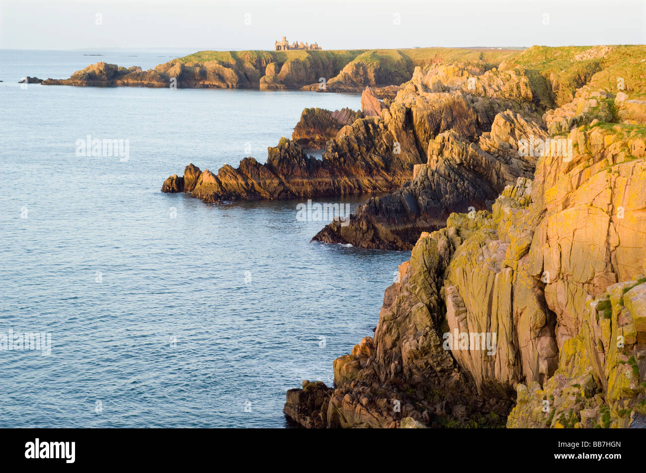 Rocky coastline and granite sea cliffs in Aberdeenshire, looking south from Dunbuy to Slains Castle and Meikle Partans. Stock Photo