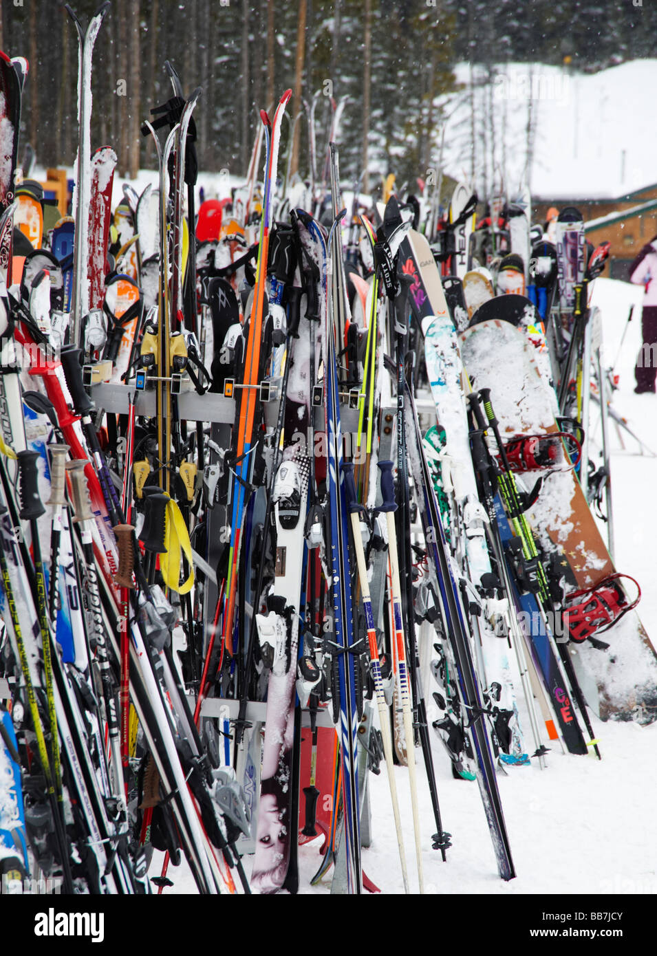Skis and snowboards leaning against rack in ski resort, Lake Louise, Banff National Park, Canada
