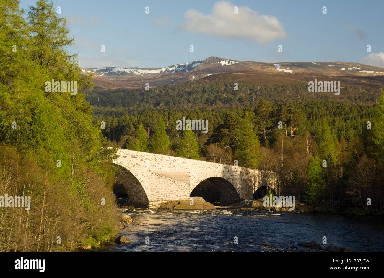 The Old Bridge of Dee at Invercauld, Braemar, looking across Ballochbuie Forest to the hills of the White Mounth. Stock Photo