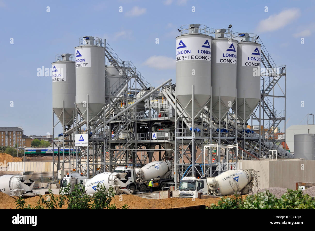 London Concrete industrial site distribution plant with cement silos aggregates storage & mixer delivery lorry truck Stratford East London England UK Stock Photo