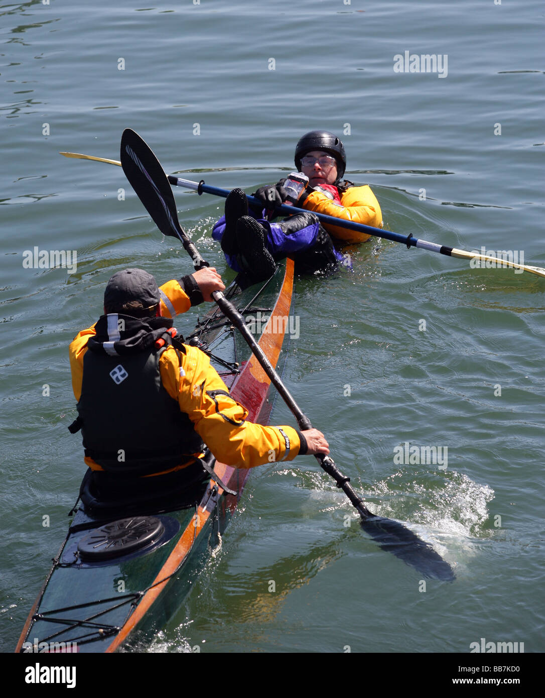 Kayakers perform rescue maneuvers off of Connecticut in Long Island Sound Stock Photo