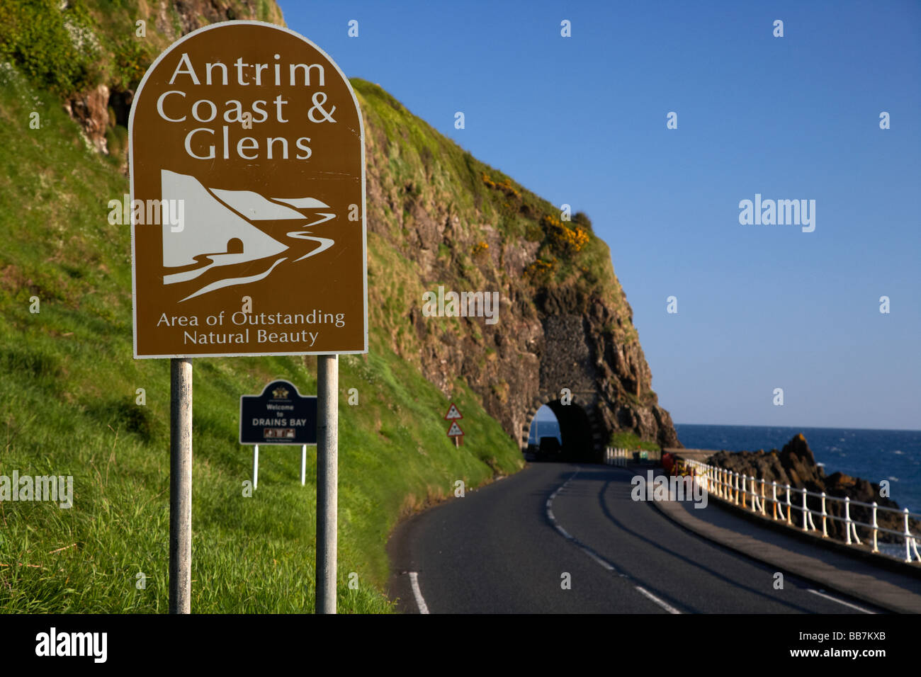 Antrim coast and glens sign on the A2 causeway coastal route coast road passes through the black arch outside Larne Stock Photo