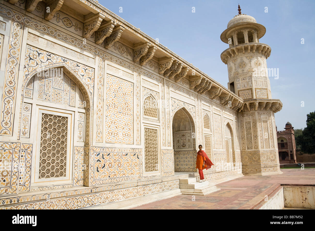 Lady standing on steps of the Itimad-ud-Daulah mausoleum, also known as the Baby Taj, Agra, Uttar Pradesh, India Stock Photo