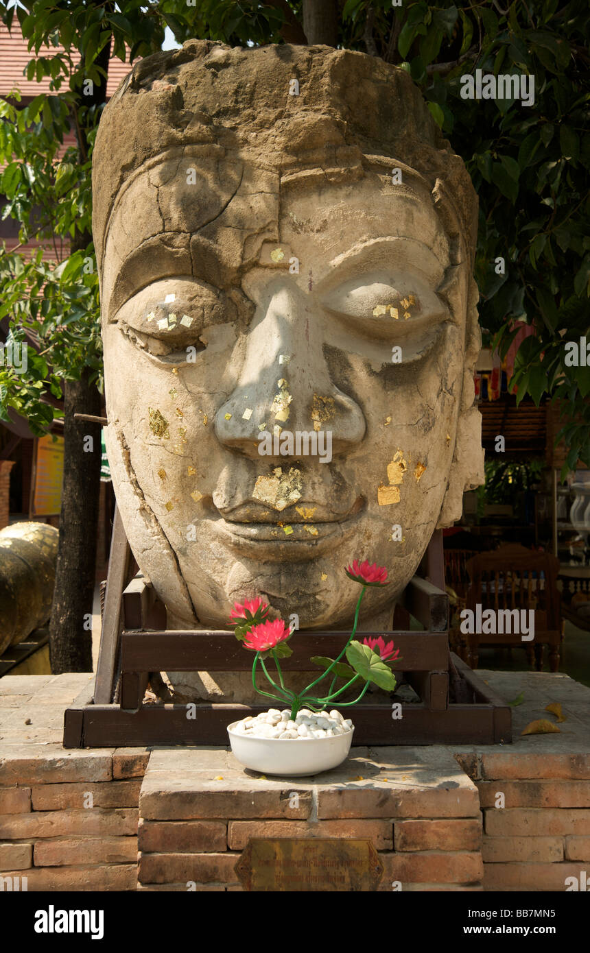 Stone Buddha head on display in the grounds of a Chiang Mai temple
