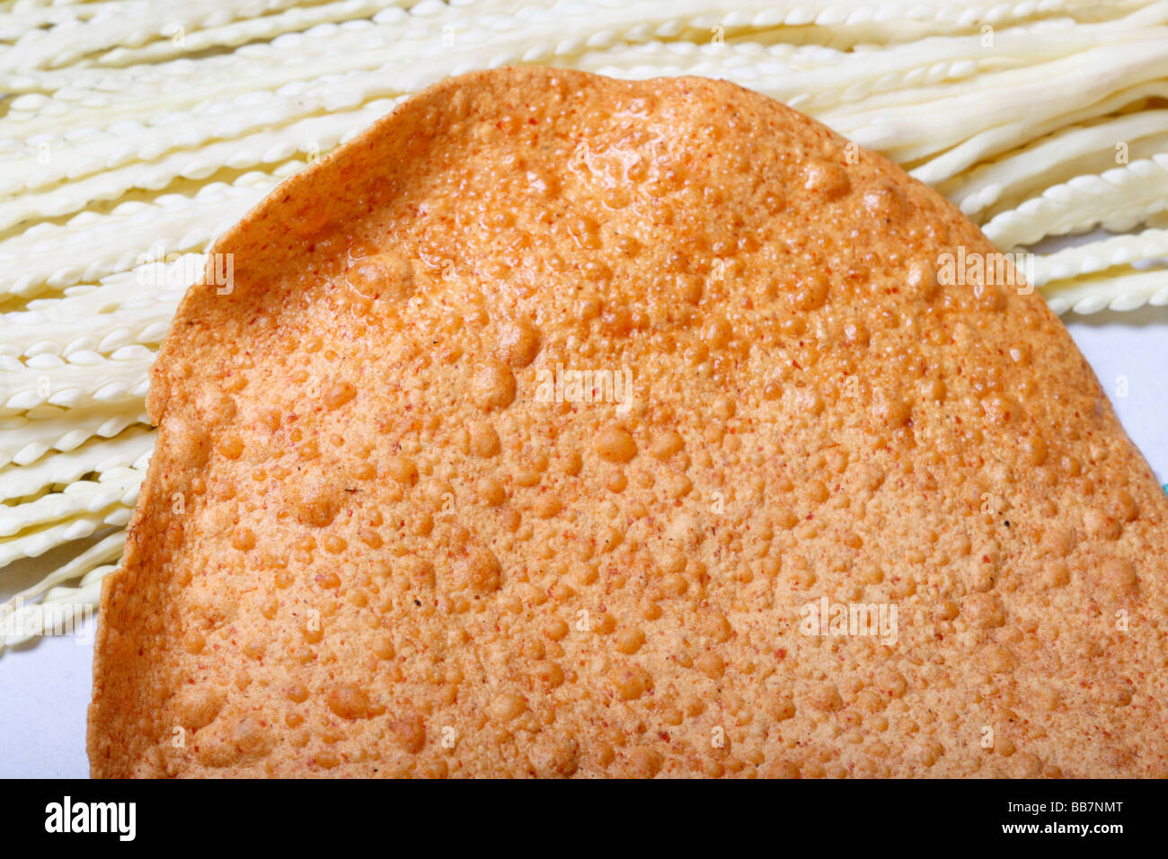 Papad is a thin, crispy Indian preparation sometimes described as a