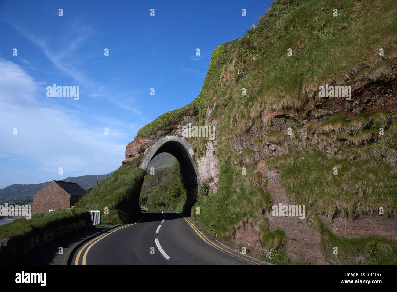 red arch formation in red bay between waterfoot and cushendall on the A2 antrim coast road county antrim northern ireland uk Stock Photo