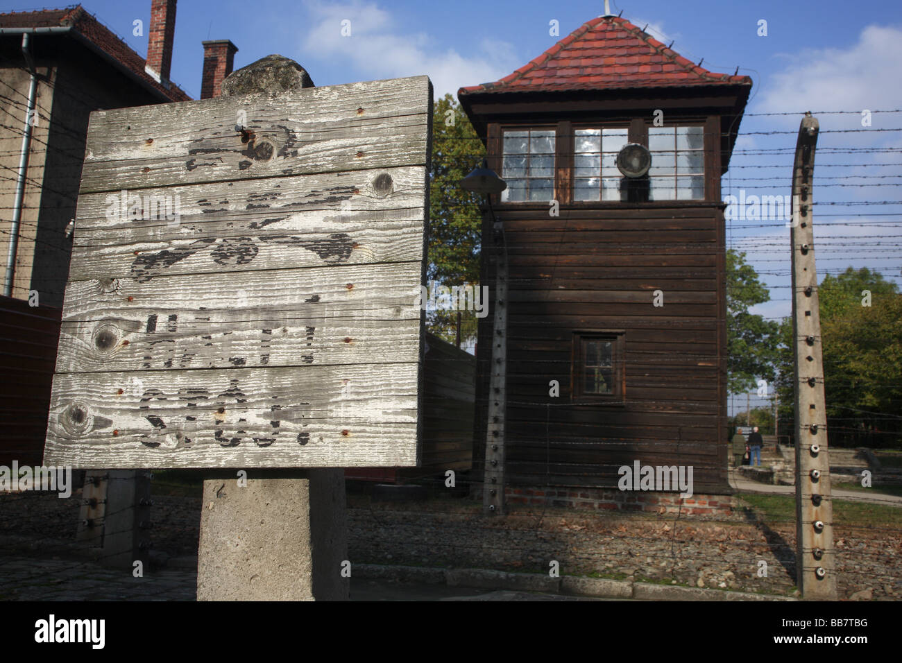 Warning sign and guard tower at Auschwitz concentration camp, Poland Stock Photo