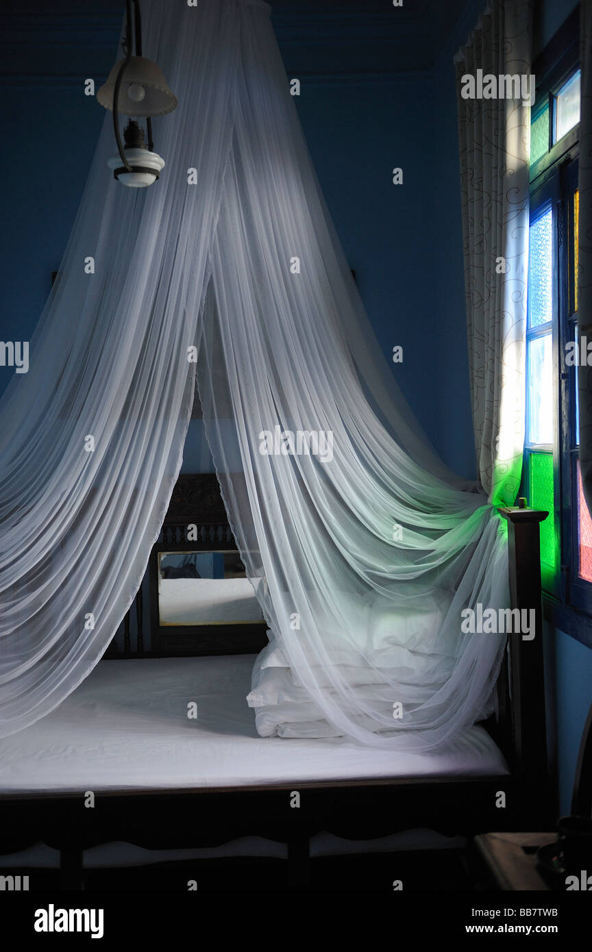White mosquito net above the bed in a hotel. Stock Photo