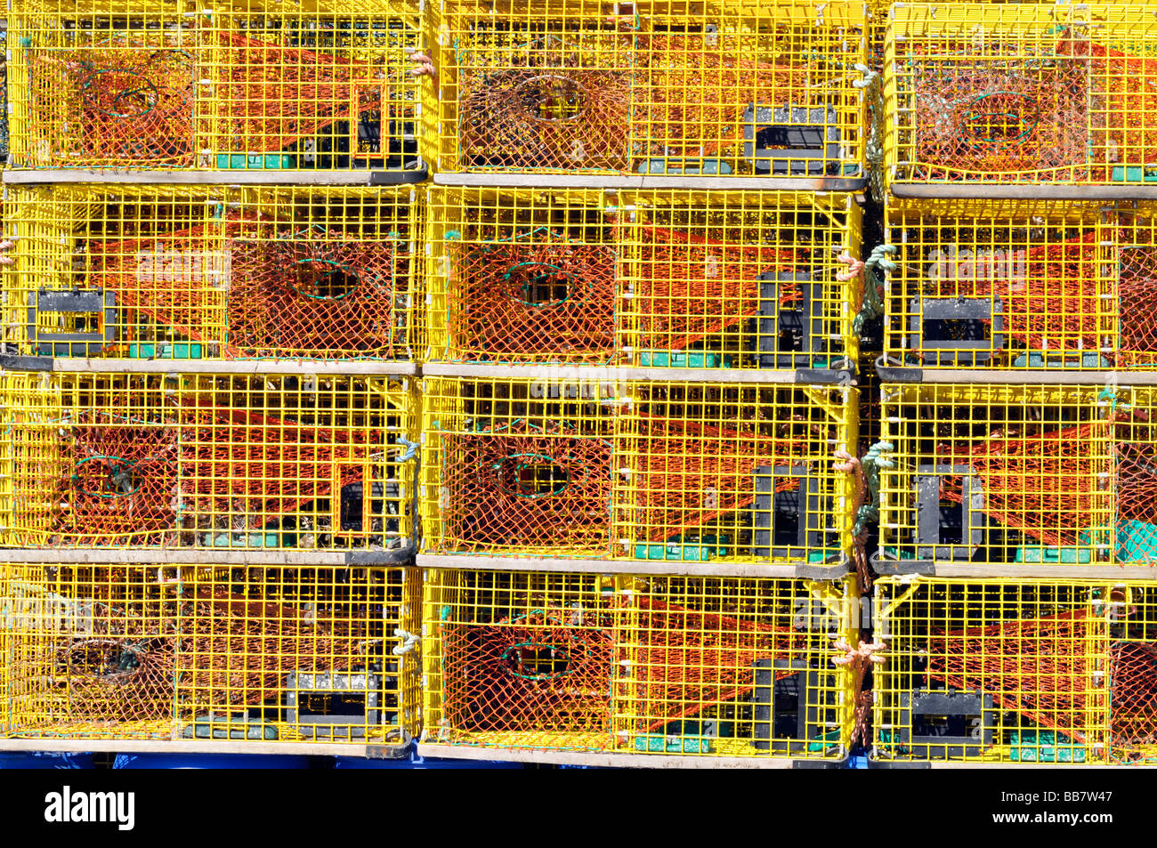 Stacks of new yellow wire lobster traps at State Pier Newport Harbor Rhode Island Stock Photo