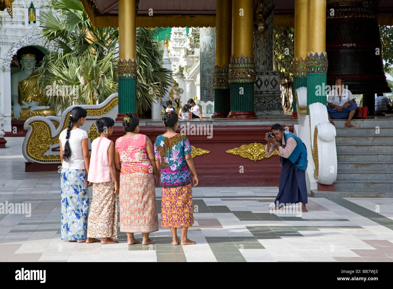 Burmese women posing for a photograph. Shwedagon pagoda. Yangon. Myanmar Stock Photo