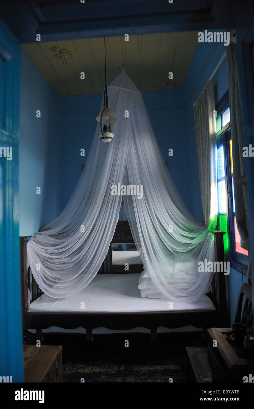 White mosquito net above the bed in a hotel. Stock Photo