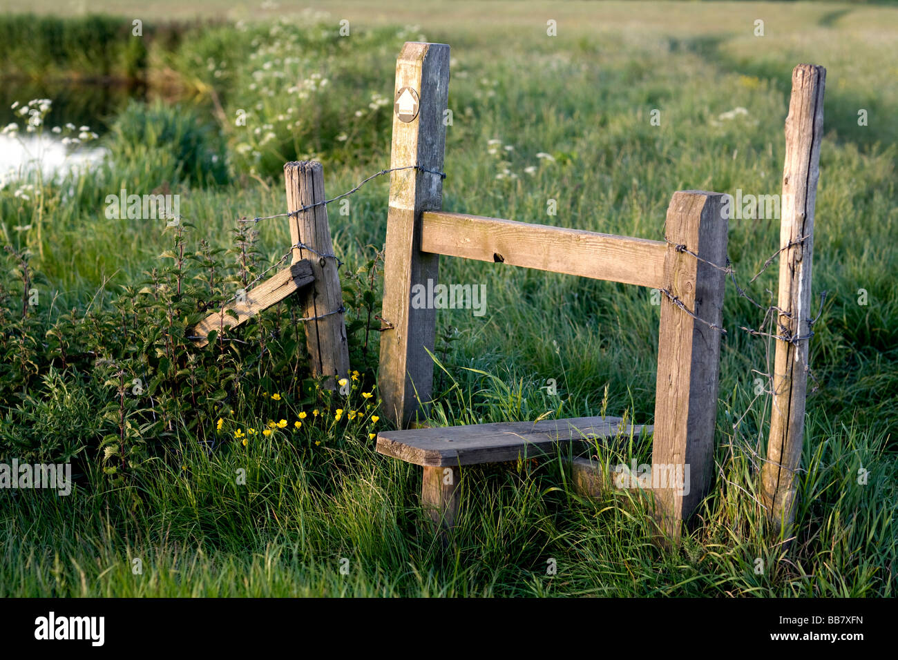 a stile over a barbed wire fence Stock Photo