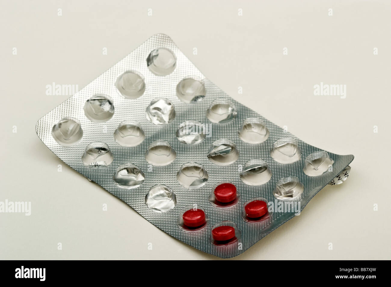 Four small red sinus pills in a foil and plastic bubble pack Stock Photo