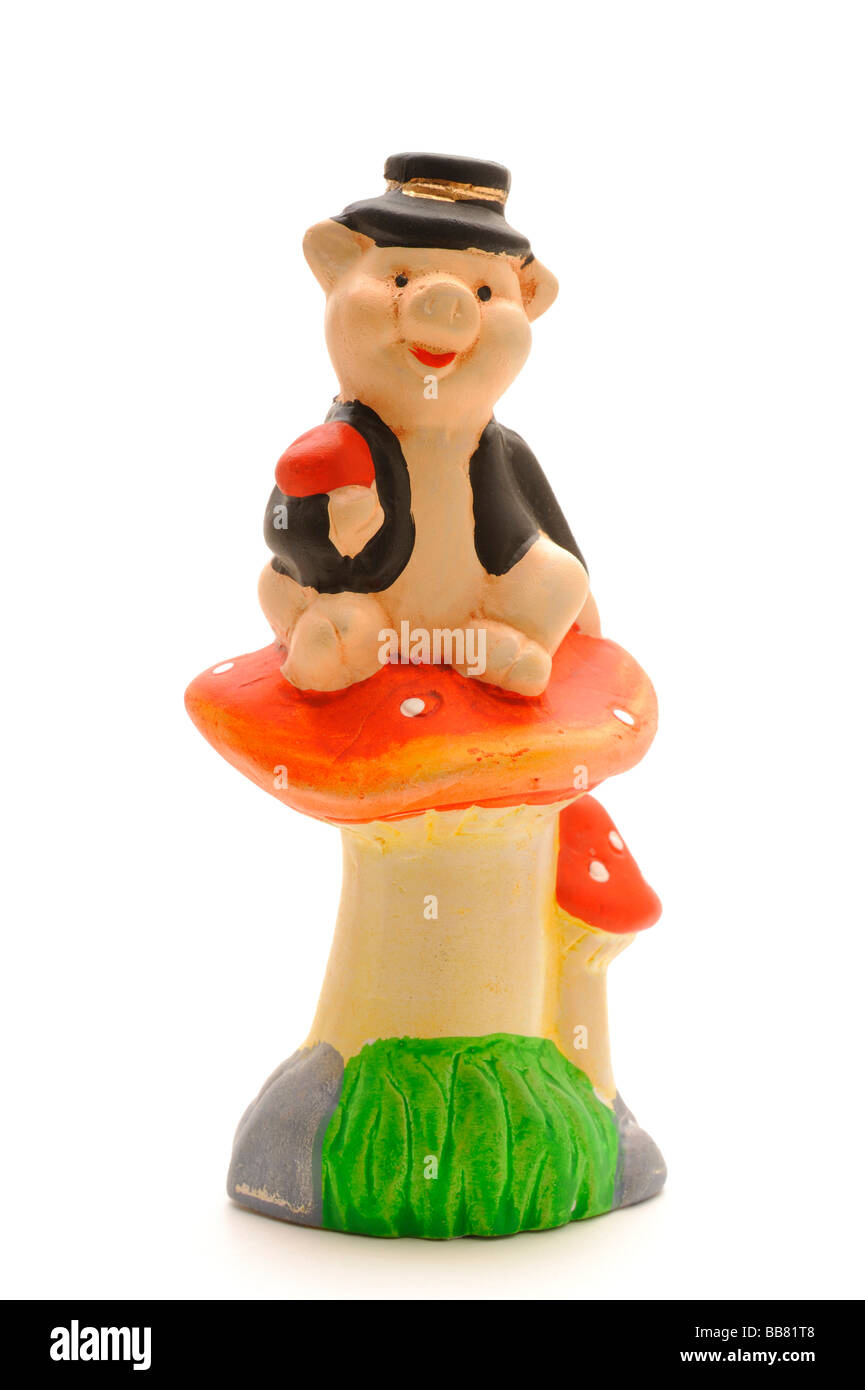 Marzipan pig sitting on a Fly Agaric Stock Photo