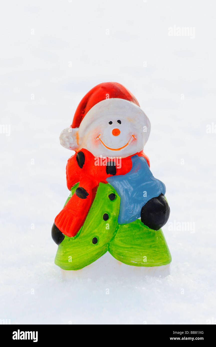 Porcelain snowman in snow Stock Photo