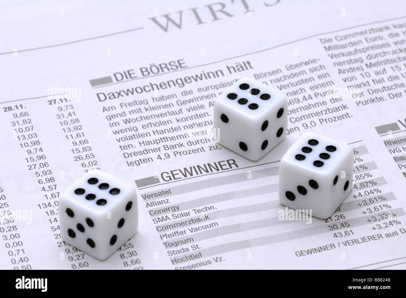 Dice on the business section of a newspaper, stock exchange, symbolic picture for business Stock Photo