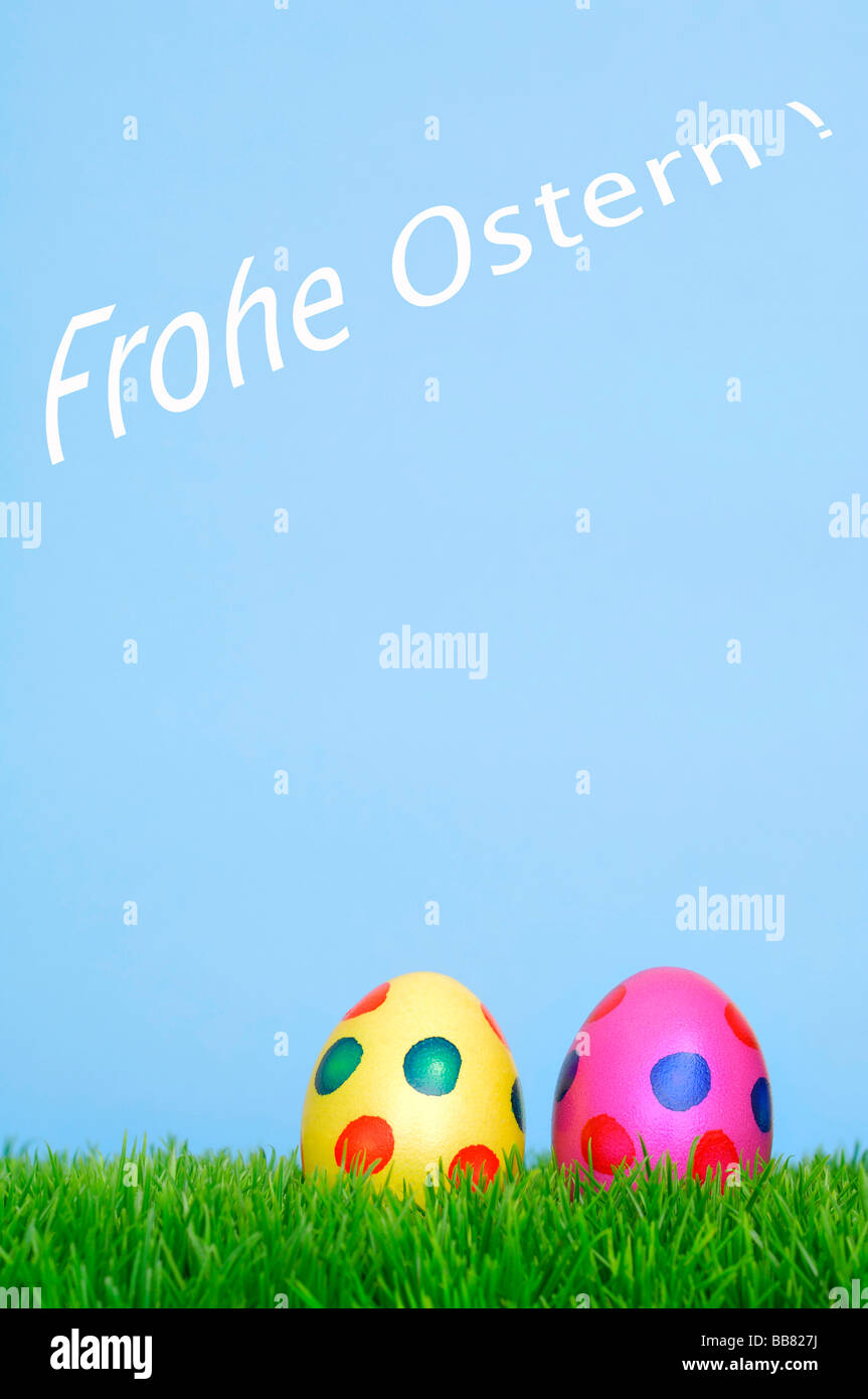 Colourful Easter eggs on grass, Frohe Ostern, happy Easter in writing Stock Photo