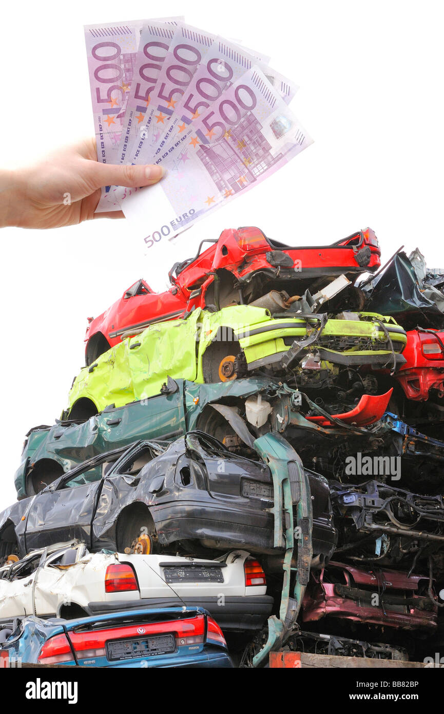 Junk cars, bank notes, symbolic picture for scrapping premium Stock Photo