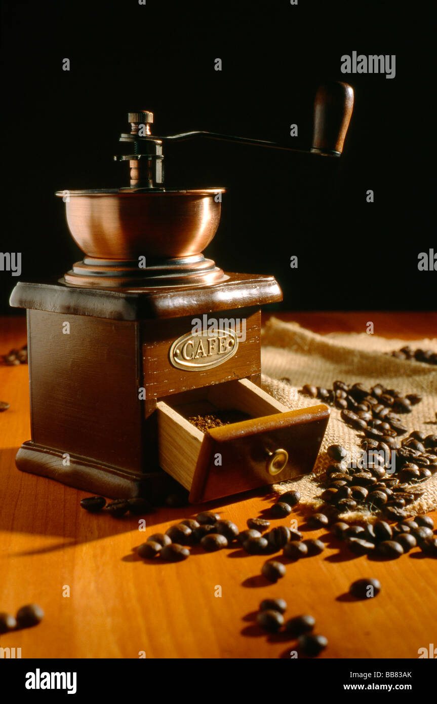 Still life about coffee A cup of black coffee two sacks with coffee beans and ground coffee make in grinder Stock Photo