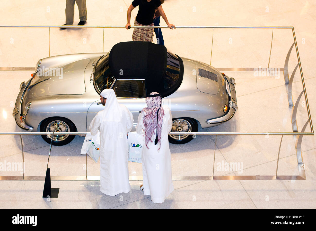 Two Sheiks in front of an old Porsche in a shopping mall, Dubai, United Arab Emirates, Near East Stock Photo