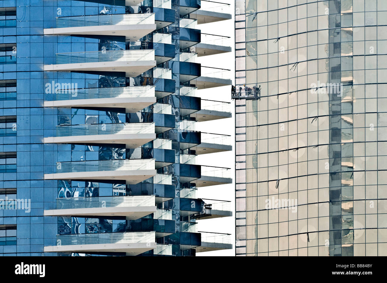 Window cleaner in front of highrise glass front, Dubai, United Arab Emirates Stock Photo