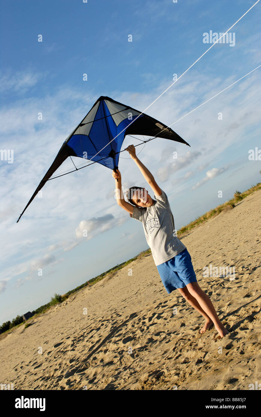 Boy flying kite, kite flying, kiting on the beach Stock Photo Alamy