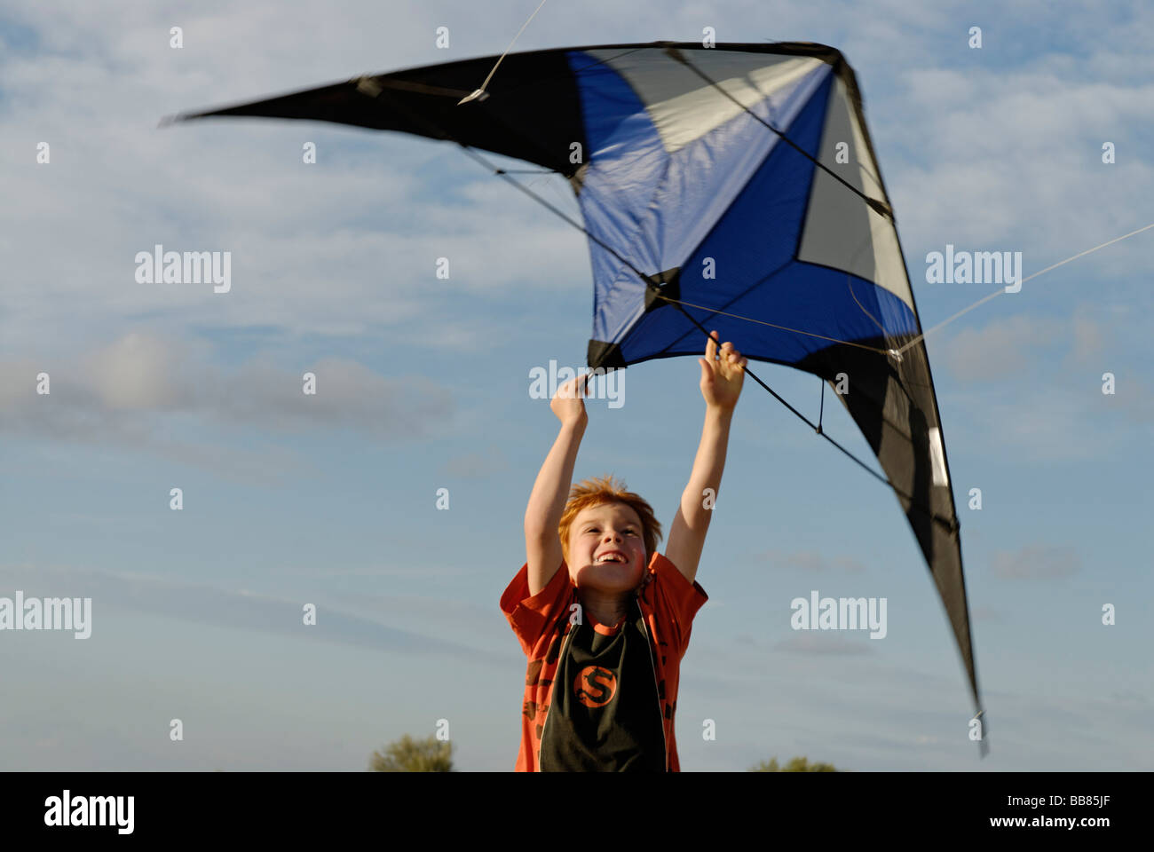 Boy flying kite, kite flying, kiting Stock Photo Alamy
