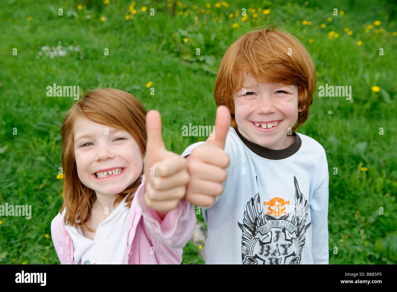 Girl And Boy Giving The Thumbs Up Stock Photo 24151741 Alamy