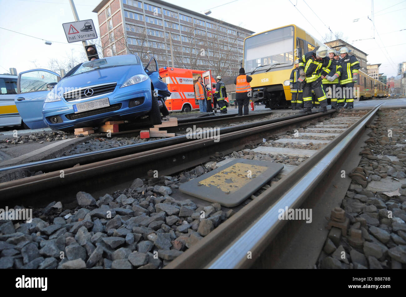 Severe traffic accident, passenger vehicle collided with a U-Bahn train, woman driver must be released by rescue crew from her  Stock Photo