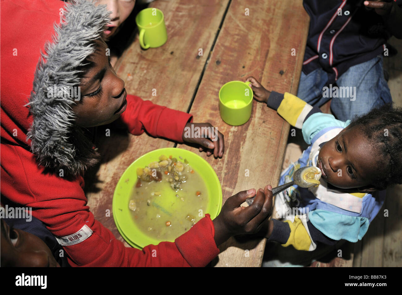 Girl, 11 years old, caring for her 2 year old sister while the mother is working, slums of Alto de Cazuca, Soacha, Bogotá, Colu Stock Photo