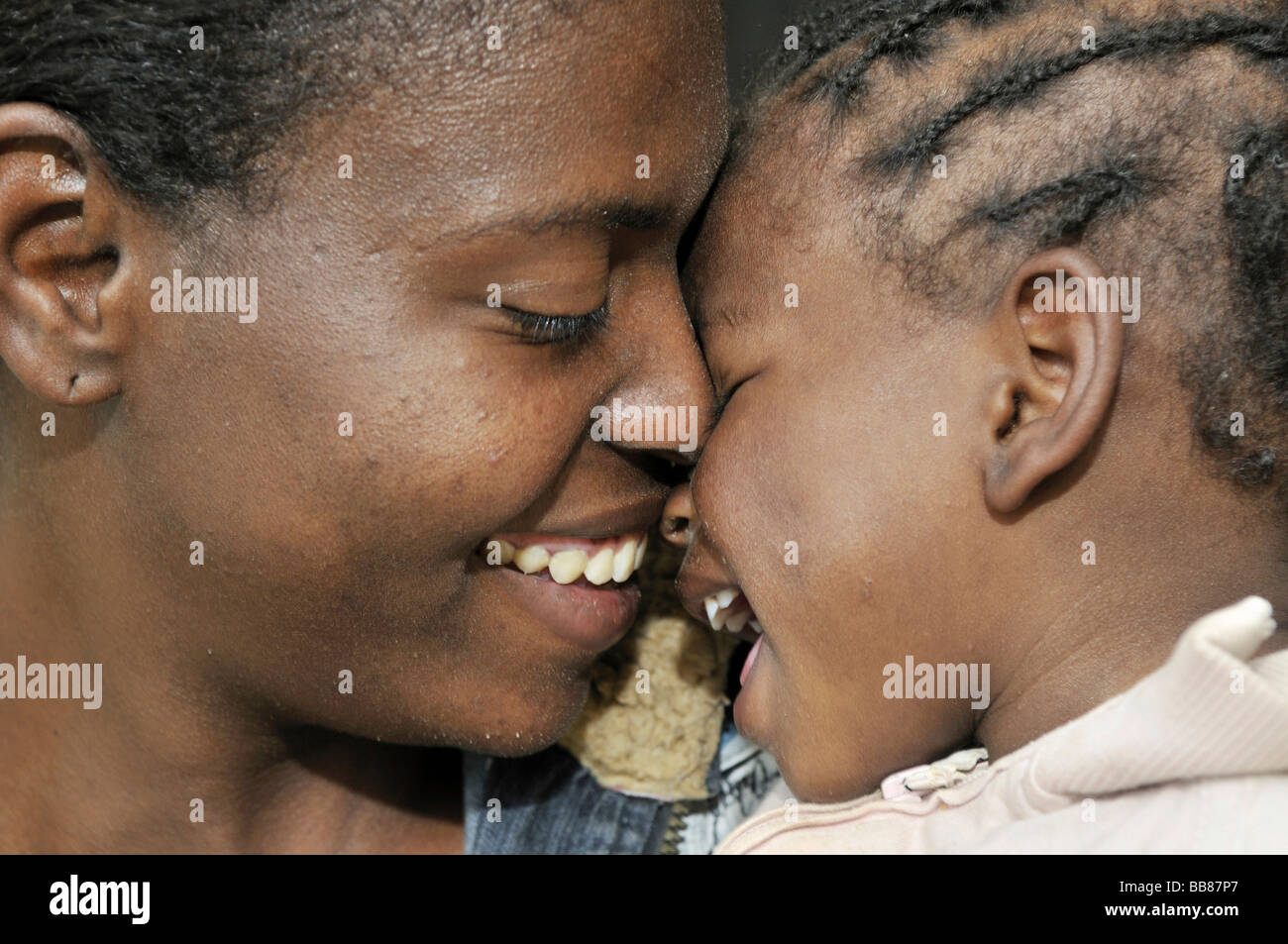 Mother and daughter, dark-skinned, hugging, slums of Alto de Cazuca, Soacha, Bogotá, Columbia Stock Photo