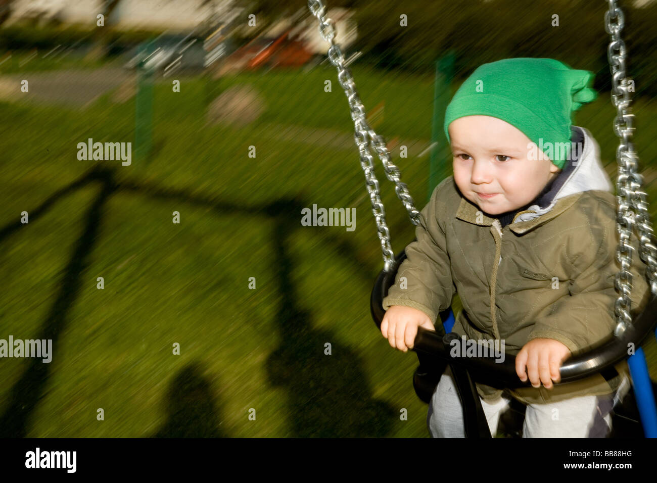 people, close-up, one, child, girl, boy, 0-5, years, hat, swing, smile, smiling, outdoor, spring, autumn, horizontal Stock Photo