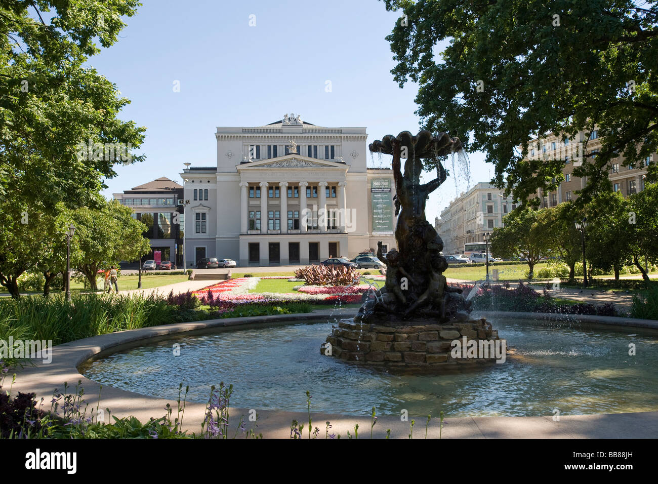 Latvian National Opera House behind a fountain in the city park, Riga ...