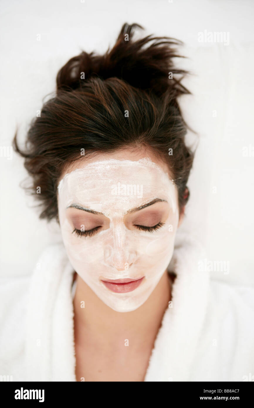 Portrait of young beauty woman's face with face pack and closing eyes Stock Photo