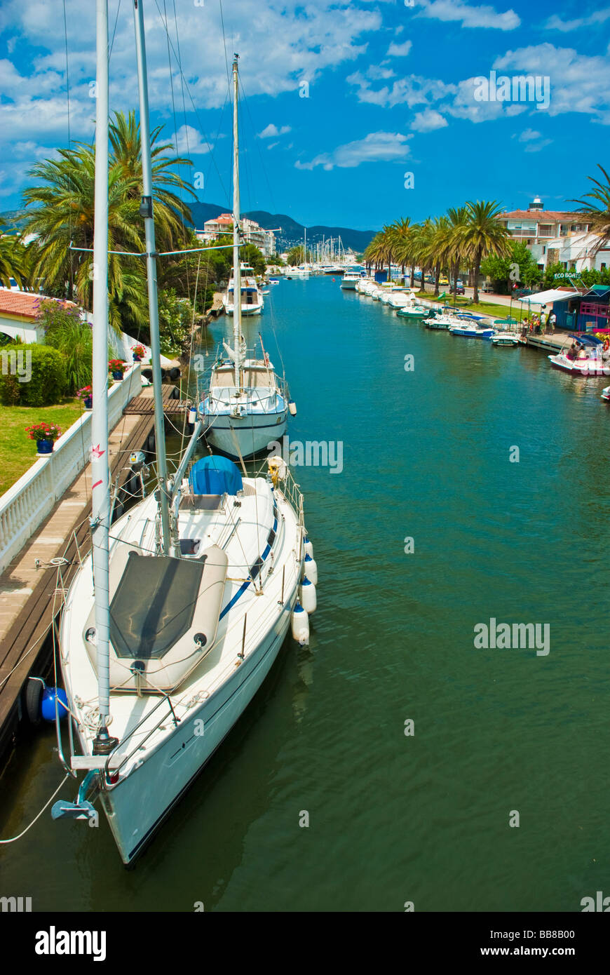 Sailing yachts and boats in a canal at Empuriabrava village with ...