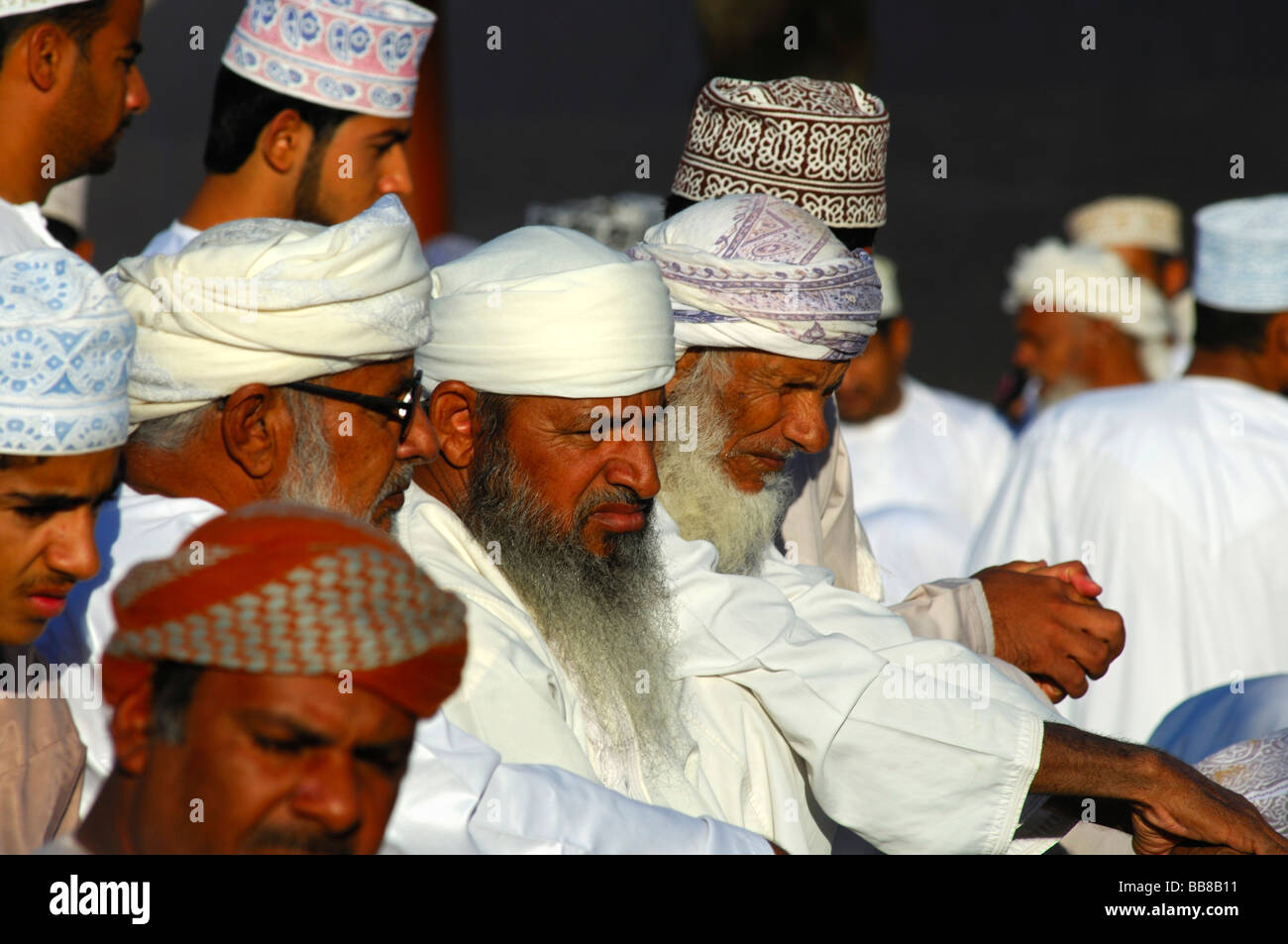 Omani men wearing a national costume Dishdasha and a Kummah cape or a Mussar turban on the head, Nizwa, Sultanate of Oman Stock Photo