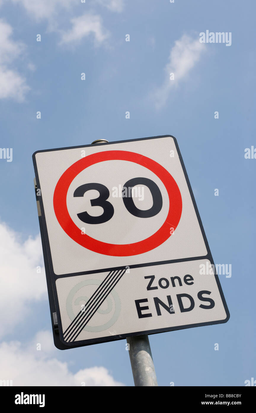Road sign showing that traffic is leaving a 20 mph zone and the speed limit is now 30 mph in a town in England Stock Photo