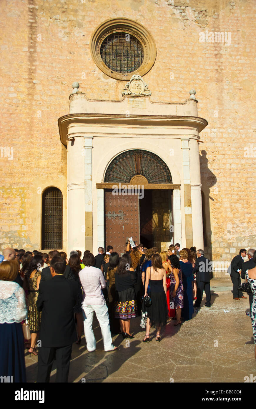 Many people entring the church Sant Bartomeu and Santa Tecla Sitges Costa Dorada Catalonia Spain Stock Photo