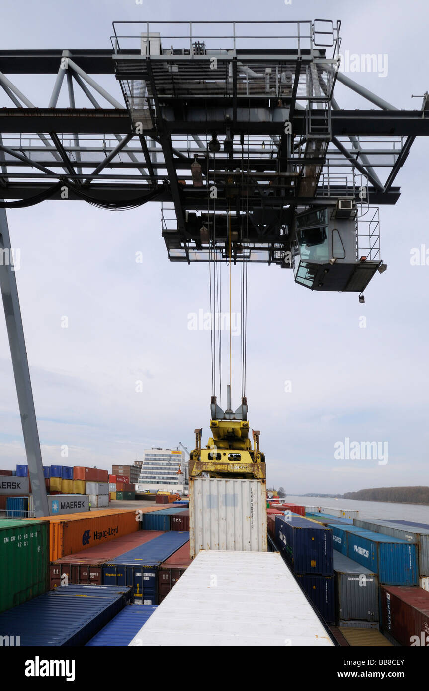 Harbour of Bonn, gantry crane letting containers down on a container ship, bimodal container handling, North Rhine-Westphalia, Stock Photo