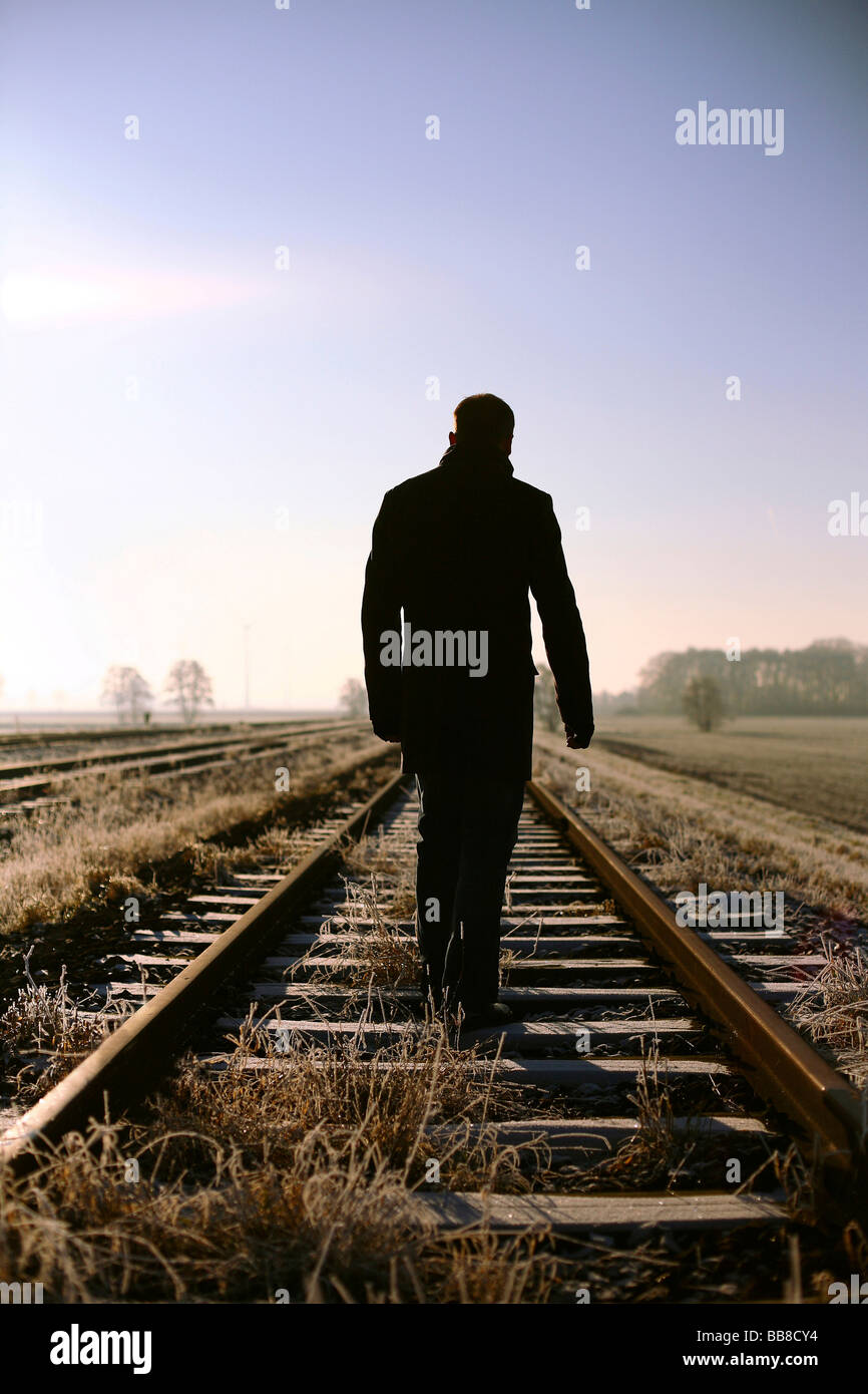 Man on rail tracks, loneliness Stock Photo