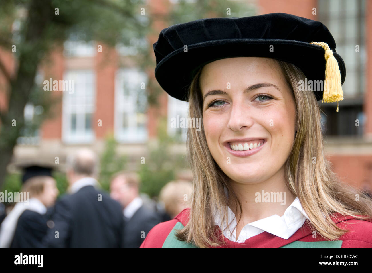 Young female university student in Doctorate graduation gown Stock Photo