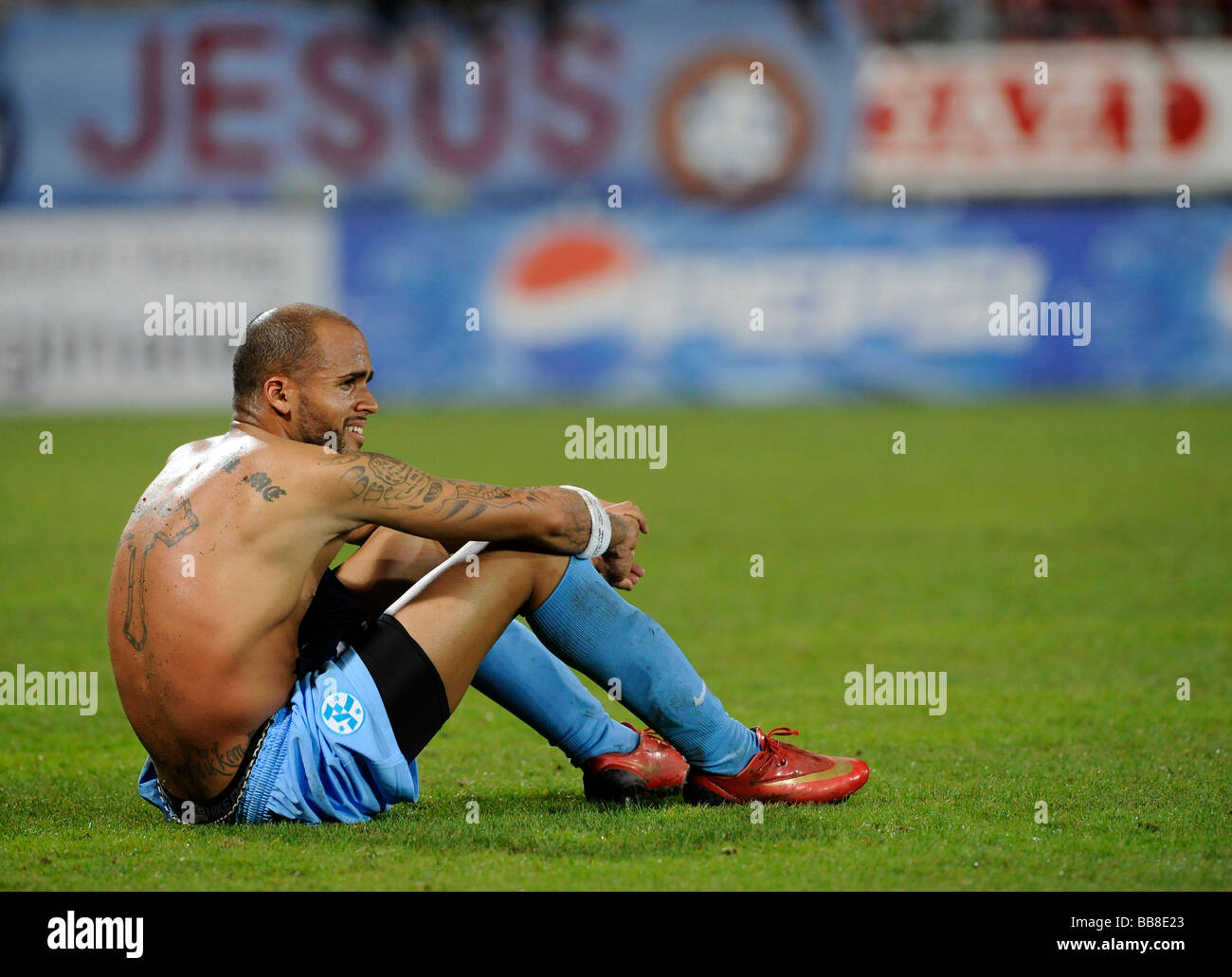 Orlando Smeekes, Stuttgarter Kickers, with religious tatoos, disappointed, sitting on the floor after losing, Jesus written on  Stock Photo