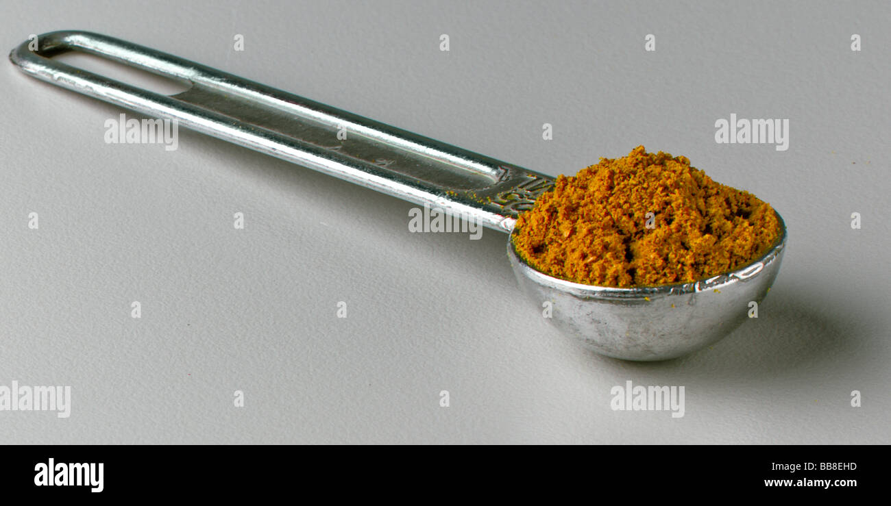 Curry powder in measuring spoon Stock Photo