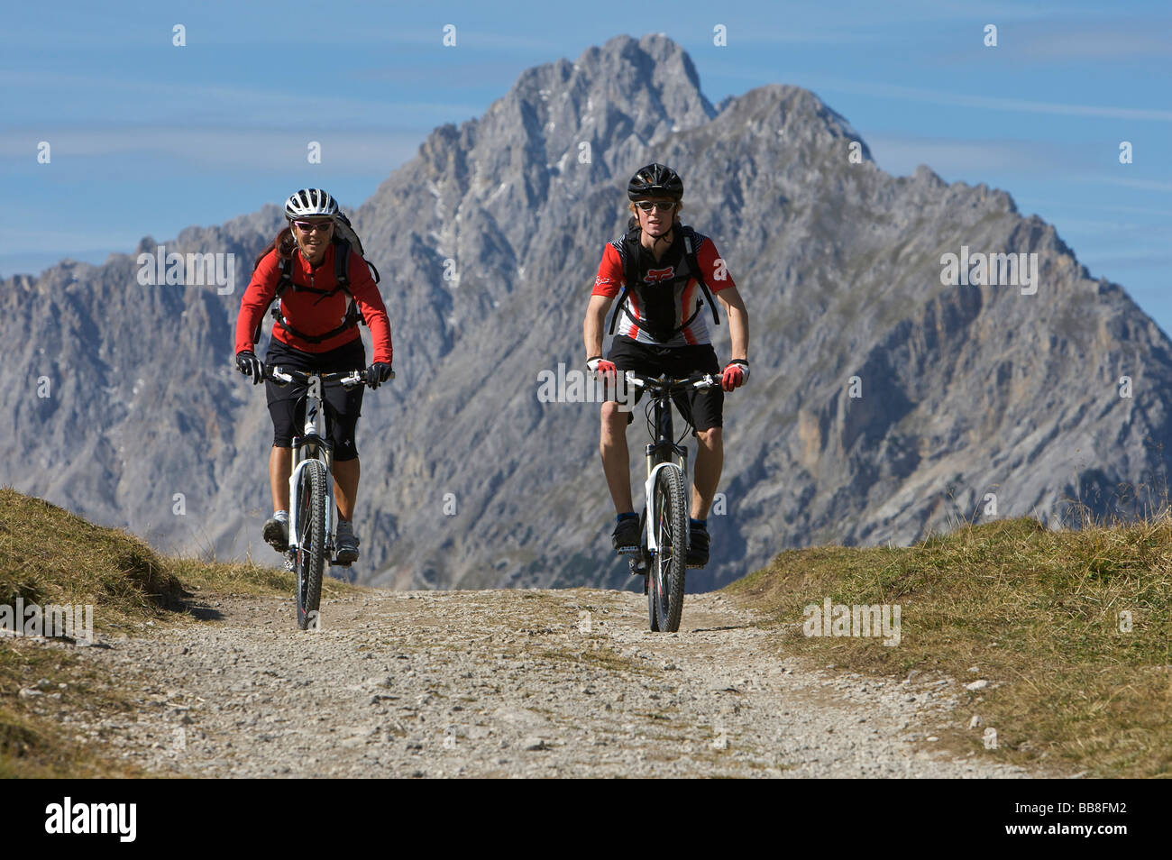 Mountainbike riders, male and female, at Hochalmsattel plateau near Karwendelhaus, alpine club house, Scharnitz, Tyrol, Austria Stock Photo