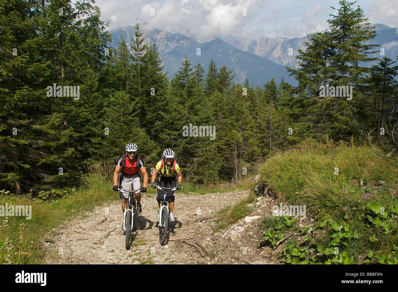 Male and female mountainbike riders northwest of Hochtoerlehuette Mountain, Ehrwald, Tyrol, Austria, Europe Stock Photo
