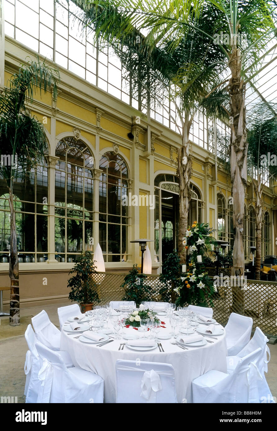 Beautifully set round table, restaurant in conservatory building from