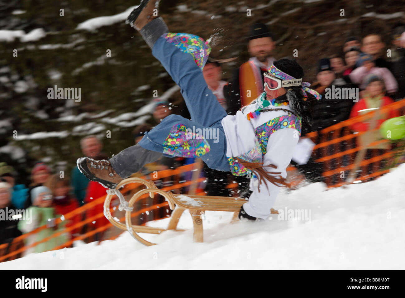 Woman falling off a sled, Gaissach schnabler and sled race, carnival custom, Gaissach, Isarwinkel, Upper Bavaria, Bavaria, Germ Stock Photo
