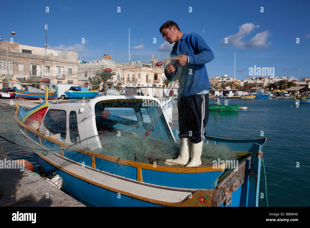 Fisherman Repairing His Net On A Fishing Boat Port Of Marsaxlokk Malta Europe Stock Photo Alamy Fisherman Repairing His Net On A Fishing Boat Port Of Marsaxlokk Malta Europe Stock Photo Alamy