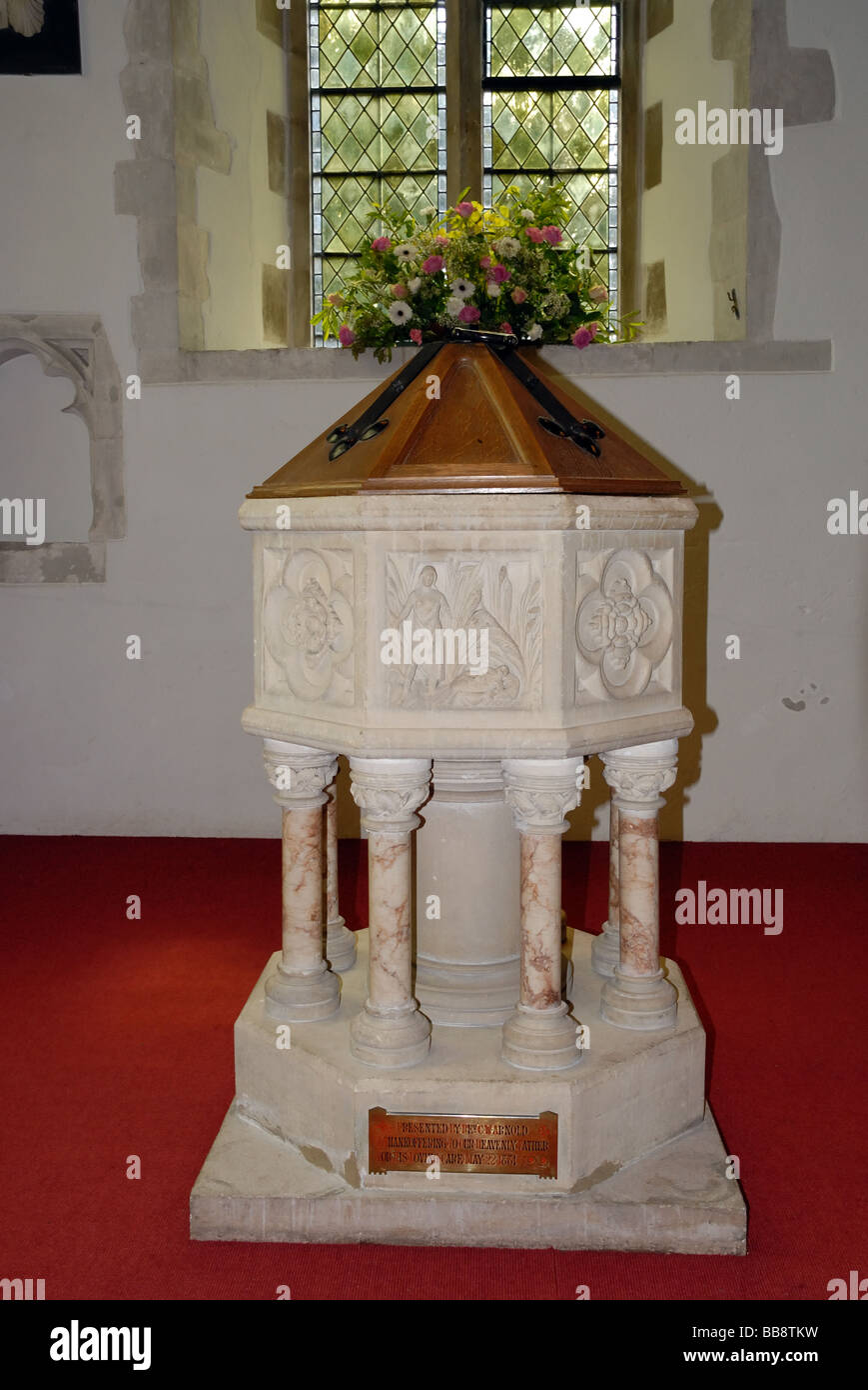 Baptismal font at St Peter s church Old Woking Surrey Presented by Rev C W Arnold May 22 1881 A Grade 1 Listed Building within Stock Photo